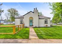 Charming home with a neatly manicured lawn, a light-blue door, and stylish architectural details at 695 W Clinton St, Danville, IN 46122