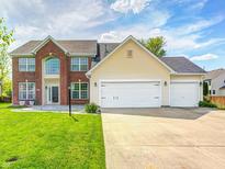 Two-story home featuring brick accents, a three-car garage, and a well-maintained lawn at 725 Bristle Lake Dr, Brownsburg, IN 46112
