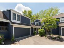 Charming two-story home with a driveway and attached garage on a sunny day at 7608 Harbour, Indianapolis, IN 46240