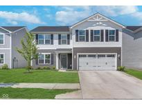 Two story home showcasing a well-manicured lawn and a gray and white exterior at 830 Black Rock Cir, Lebanon, IN 46052