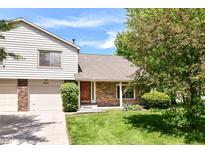 Charming two-story home with a brick and siding exterior, lush lawn, and a well-maintained front yard at 8980 Cinnebar Dr, Indianapolis, IN 46268