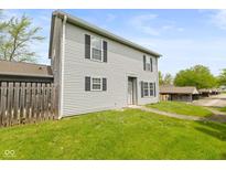 Two-story home with neutral siding, black shutters, and a well-maintained lawn, creating an inviting curb appeal at 916 Ardsley Dr, Indianapolis, IN 46234