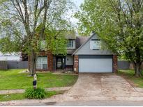 Charming two-story home with a well-manicured front lawn and mature trees at 925 Mallory Pkwy, Franklin, IN 46131