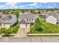 Expansive aerial view of a well-maintained home with a spacious driveway and lush landscaping at 9712 Brooks Dr, McCordsville, IN 46055