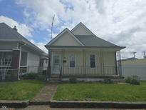 Charming single-Gathering home featuring a welcoming front porch and well-maintained lawn at 1131 S Pershing Ave, Indianapolis, IN 46221