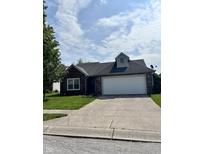 Charming single-story home featuring a spacious driveway, two-car garage, and well-maintained lawn at 1639 Park Castle Way, Indianapolis, IN 46229