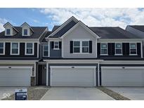Charming townhome featuring an attached garage and inviting curb appeal at 18763 Moray St, Westfield, IN 46074