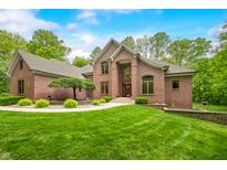 Charming brick home featuring lush landscaping and a welcoming entrance at 4128 Whitetail Woods Dr, Bargersville, IN 46106