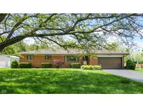 Charming brick home with an attached garage and well-manicured landscaping at 5683 Steven Dr, Greenwood, IN 46142