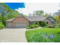 Charming brick home with a well-maintained lawn and beautiful landscaping at 5851 Beisinger Pl, Indianapolis, IN 46237
