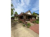 Charming home featuring a welcoming brick porch and well-maintained landscaping at 593 S 10Th S St, Noblesville, IN 46060