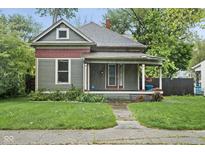 Charming craftsman-style home with a covered front porch and lush landscaping at 6159 Broadway St, Indianapolis, IN 46220