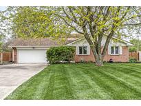 Charming brick home featuring a well-manicured lawn and mature trees, enhancing its curb appeal at 745 N Madison St, Fortville, IN 46040