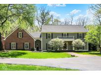 Inviting front exterior featuring a two-story home, well-manicured lawn and beautiful landscaping at 8820 Mud Creek Rd, Indianapolis, IN 46256