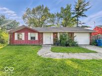 Charming single-story home featuring a two-car garage and a well-maintained front yard at 9526 Burrwood Ct, Indianapolis, IN 46235