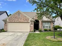 Charming single-Gathering home with brick facade, attached garage, and well-manicured lawn at 10305 Lakeland Dr, Fishers, IN 46037