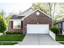 Charming single-Gathering home with a brick facade, attached two-car garage and well-manicured lawn at 1041 Lincoln Park E Dr, Greenwood, IN 46142