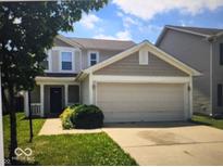 Charming two-story home with a two-car garage and covered front porch, surrounded by a well-maintained yard at 10425 Candy Apple Ln, Indianapolis, IN 46235
