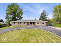 Charming single-story home featuring a circular driveway and well-maintained lawn at 10456 N State Rd 267, Brownsburg, IN 46112