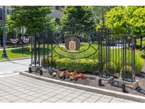 Ornate wrought iron sign welcomes you to The Village of West Clay with landscaping and brick-paved road at 12722 Moonseed Dr, Carmel, IN 46032