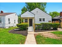 Charming home featuring a welcoming porch, manicured landscaping, and a convenient carport at 1337 N Concord St, Indianapolis, IN 46222