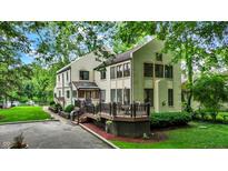 Inviting two-story home featuring a spacious deck and lush green landscaping at 1530 E 75Th St, Indianapolis, IN 46240