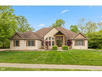 Stunning single Gathering home featuring a stone and brick facade, manicured lawn and mature trees at 1832 Live Oak Ct, Avon, IN 46123