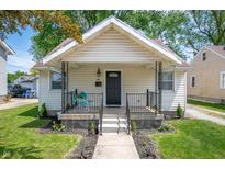 Charming home featuring a cozy front porch and a well-maintained lawn with fresh landscaping at 1912 Broadway St, Anderson, IN 46012