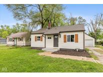 Charming single-story home featuring neutral siding, wood shutters, and a well-maintained yard at 2006 N Moreland Ave, Indianapolis, IN 46222