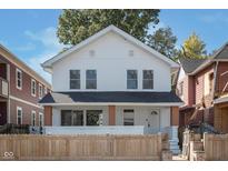 Charming two-story home with a well-maintained front yard and a classic white exterior at 2442 Guilford Ave, Indianapolis, IN 46205
