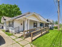 Charming single-story home with a wooden wheelchair ramp and covered porch entry at 3631 Columbus Ave, Anderson, IN 46013