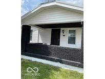 Charming home exterior featuring a quaint front porch with black brick and a freshly painted entrance at 3720 W 16Th St, Indianapolis, IN 46222