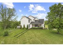 Charming two-story home featuring a manicured front lawn and a welcoming porch at 4749 Maple Grove Rd, Martinsville, IN 46151