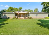 Inviting single-story home with a covered front porch and well-manicured lawn at 48 W Adams Brick Ave, Martinsville, IN 46151