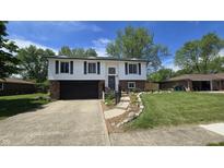 Charming split-level home featuring a well-manicured lawn and an attached two-car garage at 492 Pelenor Dr, Franklin, IN 46131