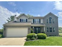 Traditional two-story home with a gray brick facade, well-manicured lawn, and an attached two-car garage at 523 Torrey Ct, Avon, IN 46123