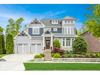 Stunning two-story home featuring a meticulously landscaped front yard and a three-car garage at 6734 W Stonegate Dr, Zionsville, IN 46077