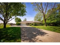 Charming ranch home with mature trees, a long driveway, and a well-maintained front lawn at 7285 E County Road 900 N, Brownsburg, IN 46112