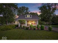 Charming home at dusk with professionally landscaped front yard at 744 Gilbert Ave, Indianapolis, IN 46227