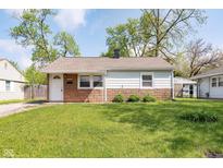 Charming single-story home featuring a well-maintained lawn and a classic brick and siding facade at 8144 E 50Th St, Indianapolis, IN 46226