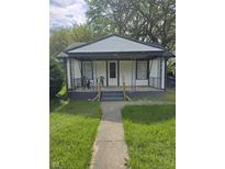 Charming single-story home with a cozy front porch and well-maintained lawn at 114 S Catherwood Ave, Indianapolis, IN 46219