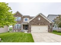 Charming two-story brick home with a well-maintained lawn and attached two car garage at 11818 Bellhaven Dr, Fishers, IN 46038