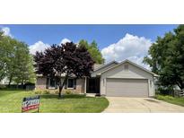 Charming one-story home featuring a well-maintained lawn, an attached garage, and lovely landscaping at 12974 Shandon Ln, Fishers, IN 46038