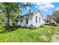 Charming two-story home with white siding and a well-maintained lawn in a residential neighborhood at 1610 S F St, Elwood, IN 46036