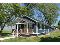 Charming single-story home with a blue exterior, well-maintained lawn, and inviting front porch at 2009 Draper St, Indianapolis, IN 46203