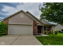 Charming two-story home with a brick facade, siding, attached garage, and a well-manicured front lawn at 2416 Foxtail Dr, Plainfield, IN 46168