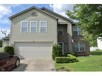 Two-story home featuring vinyl siding, brick accents, manicured landscaping, and an attached two car garage at 4274 Blackwood Ct, Greenwood, IN 46143