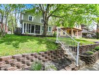 Landscaped front yard with brick retaining wall and steps leading to home's entrance at 4447 N College Ave, Indianapolis, IN 46205