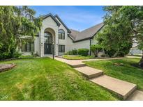 Stunning two-story home featuring a beautifully landscaped front yard and a charming, inviting entrance at 4601 Fairhope Dr, Indianapolis, IN 46237