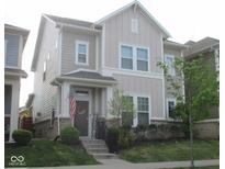 Charming two-story home with inviting front porch and well-manicured lawn exudes curb appeal at 5755 Buskirk Dr, Indianapolis, IN 46216